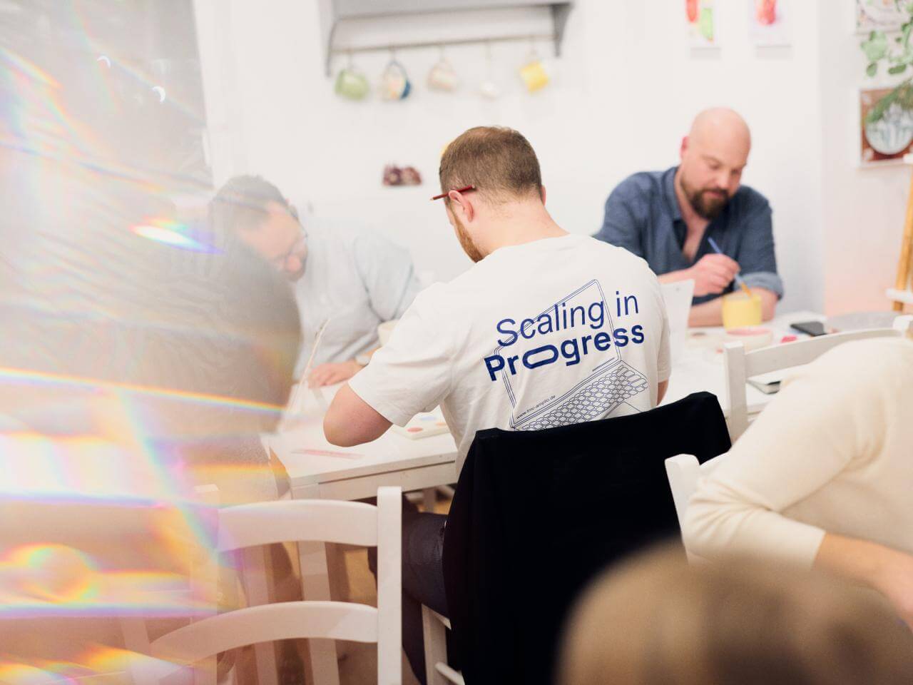 Team-Event: Gruppe von Personen beim Keramik bemalen.